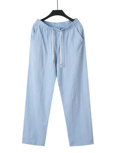Full view of light blue men's cotton linen straight pants with drawstring waist.