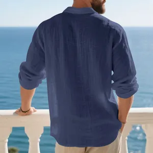 Rear view of a navy blue long-sleeved linen polo shirt for men on a sea balcony