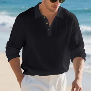 Detail of a casual men's long-sleeved polo shirt in black linen fabric with lapel collar.