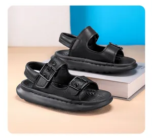 Close-up of black children's sandals with chunky soft sole and buckle straps