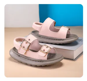 Pink children's sandals with gold buckles and soft grey soles for summer beach wear