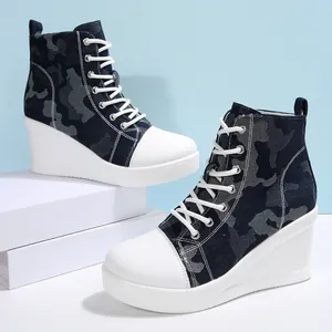 Close-up detail of women's camouflage high-top wedge sneakers with thick platform soles