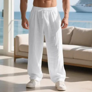 Close-up detail of white loose men's linen lounge pants with elastic drawstring waist.