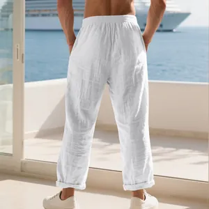Back view of white loose men's linen casual pants for a relaxed holiday look