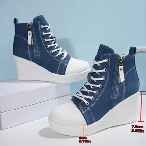 Detail view showing the 7.5cm wedge heel and 2cm platform of blue denim sneakers.