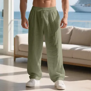 Detailed view of men's loose linen casual pants in olive green featuring a drawstring waist