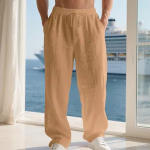 Close-up of lightweight men's loose linen trousers in casual tan color for vacation.