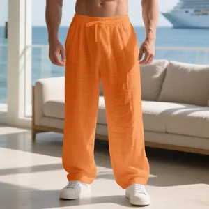 Lightweight orange linen blend casual trousers for men in a bright summer resort setting