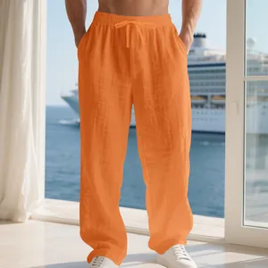 Close-up of vibrant orange linen-texture casual drawstring trousers for men on balcony