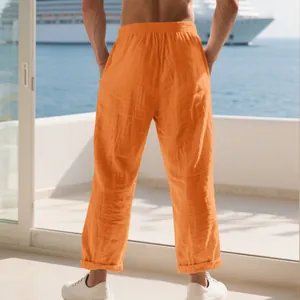 Back view of men's orange linen casual pants with loose fit for beach or home wear