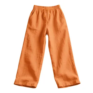 Detailed view of orange loose-fit linen pants for men showing high-quality fabric texture