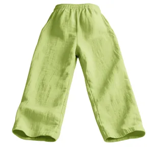 Detail view of lightweight men's loose-fit linen trousers in a pale lime green shade