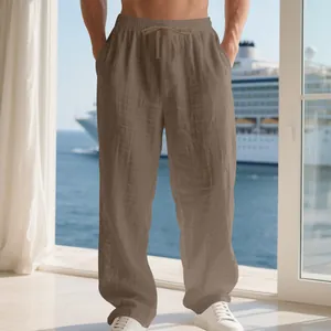 Macro view of men's loose brown linen trousers showing fabric texture and drawstring waist