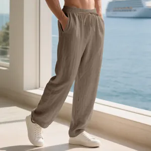 Side view of men's loose khaki linen pants on a model at a sunny resort balcony
