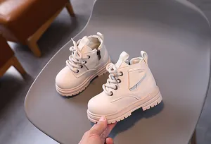 Detailed close-up view of beige toddler Martin boots with lace-up and side zipper design