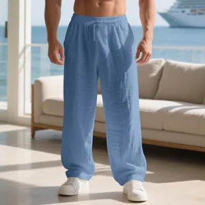 Men's relaxed fit blue linen lounge pants with drawstring waist shown in a vacation setting