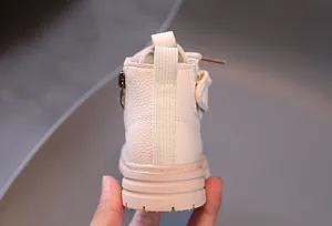 Beige children's Martin boots featuring side pocket and textured sole detail view