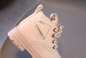 Close-up of beige children's Martin boot showing leather texture and stitching