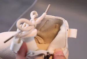 Detailed macro view showing the soft breathable interior lining of children's white Martin boots