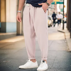 Macro view of men's pink harem joggers featuring a loose drop crotch and street style fit