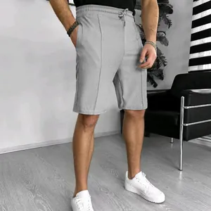 Close-up of men's grey waffle knit shorts featuring breathable fabric and drawstring waist