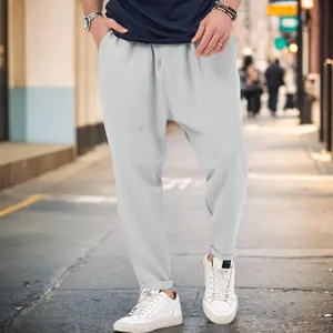 Stylish men's light gray drop-crotch harem pants designed for casual urban street wear lifestyle