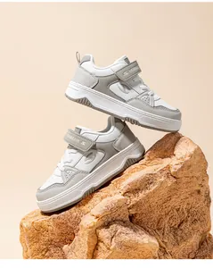 Fashionable children's white and grey board shoes with HOBIBEAR logo displayed on rock