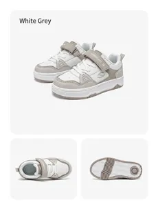 Detailansicht von Kinder-Skateschuhen in Weiß und Grau mit Klettverschluss und rutschfester Sohle
