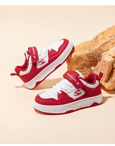 Detailed shot of red and white children's board shoes with HobiBear logo on a rock prop