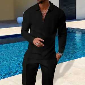 Close-up of black waffle knit texture on men's half-zip polo shirt and trousers set