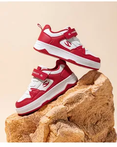 Close-up of stylish red and white HOBIBEAR children's sneakers displayed on a rock.