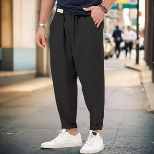 Stylish men's black harem pants with a relaxed drop-crotch design in a street setting