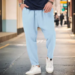 Men's stylish light blue harem pants featuring a trendy drop crotch and cuffed hem
