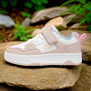 Stylish pink and white children's casual board sneakers for girls in nature