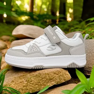 Stylish children's white and grey sneakers for boys and girls in outdoor forest setting