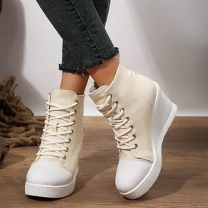 Close-up of stylish off-white wedge canvas shoes with lace-up design for women