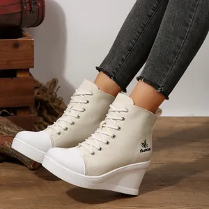 Stylish white canvas high top wedge sneakers with lace-up closure and butterfly logo