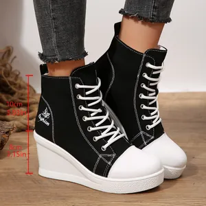 Detail view of black wedge canvas sneakers with 8cm heel and 10cm shaft height