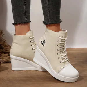 Side view of women's beige wedge canvas high-top shoes with butterfly print detail