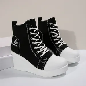Side view of black and white wedge canvas high-top shoes with lace-up detail