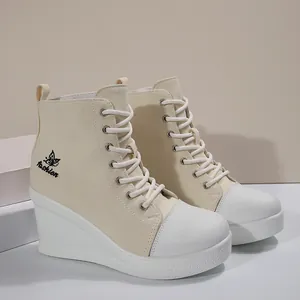 Detailed side view of cream wedge heel canvas sneakers with lace-up design