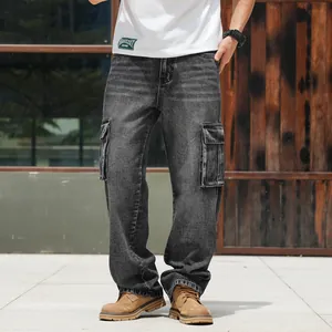 Men's dark gray wide-leg cargo denim jeans shown in a lifestyle outdoor setting
