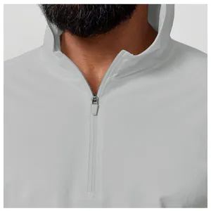 Close-up of the zipper and collar on a light grey men's hooded sun protection shirt.