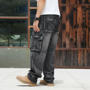 Macro view of side cargo pockets on dark washed wide-leg denim pants