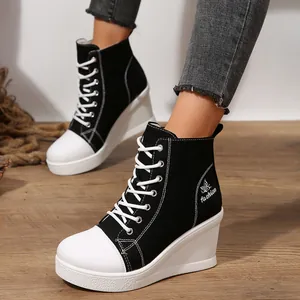 Fashionable women's high top wedge canvas shoes with lace-up design in black and white.
