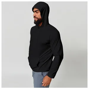 Close-up of men's black hooded quick-dry long sleeve athletic shirt with half-zip detail