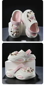 Detailed multi-angle views of children's non-slip cream and pink clogs with cute sheep charms