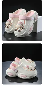 Detailed view of children's pink and white garden clogs featuring a cute sheep charm