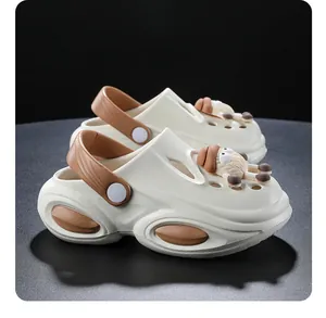 Close-up of children's off-white clogs with cute 3D sheep charms and thick soles