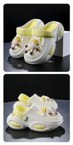 Detailed side and front view of cream children's slip-on clogs with sheep charms